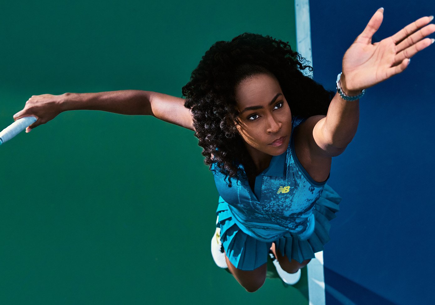 Coco Gauff seen from above on a green and blue court