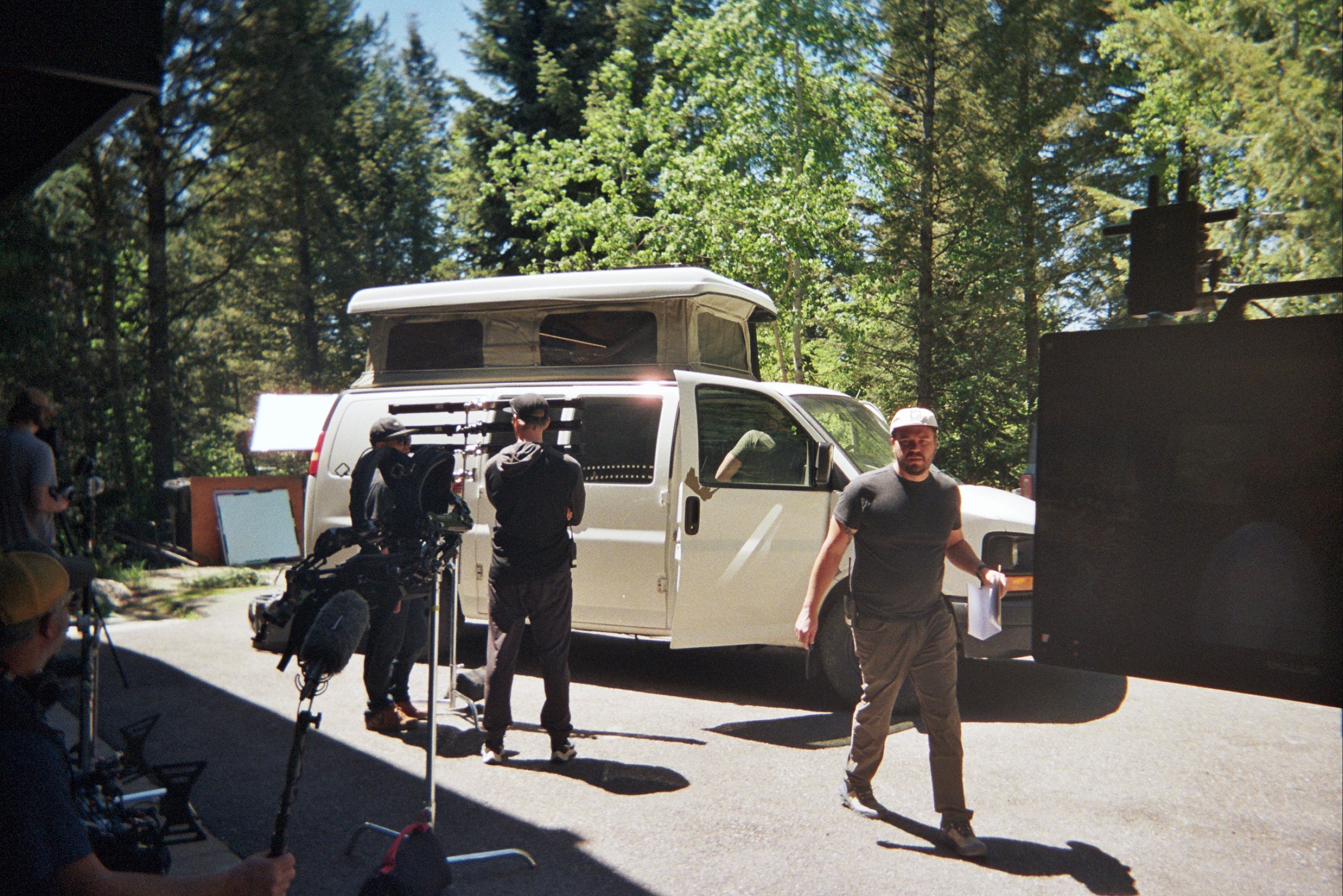 The Spry crew setting up cameras beside a pop-top van in the pines
