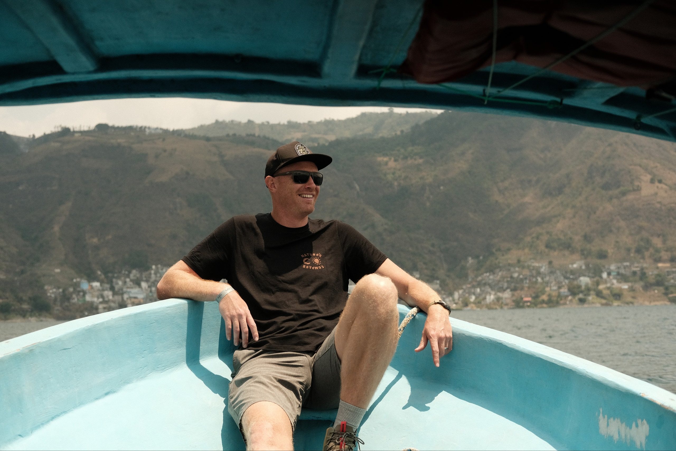 Derek Miller in the bow of a boat in Guatemala