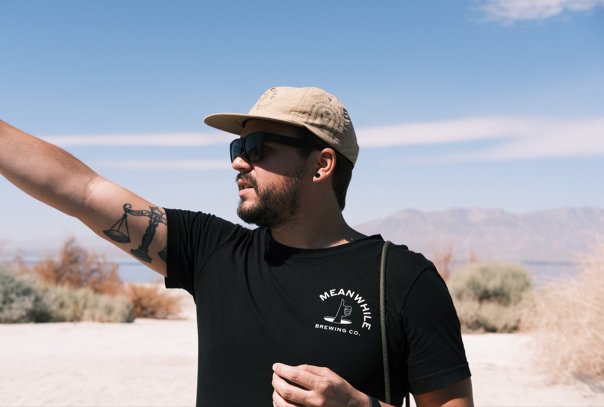 Josh Hemingway pointing across the desert on location