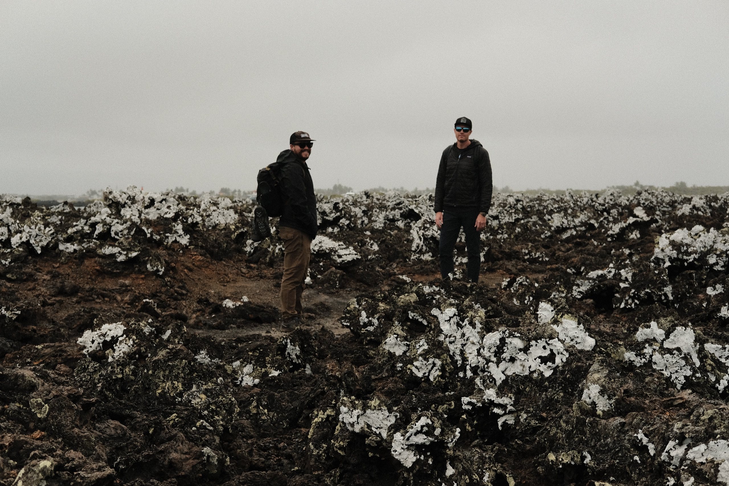 Derek and Josh standing on a rough lava field on Isla Isabela, Galápagos