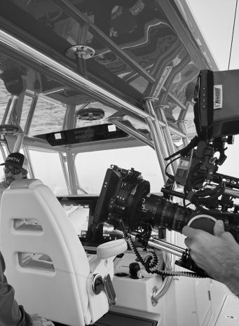 A cinema camera rig at the console of the boat