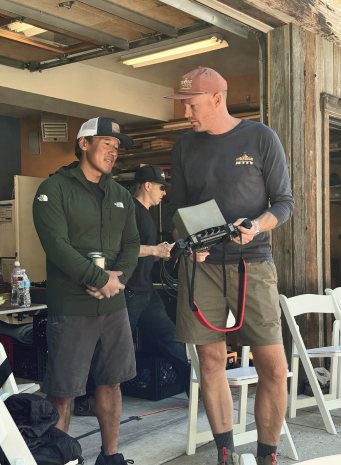Jimmy Chin and two crew members talking in the garage